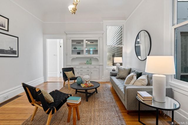 a living room with furniture a rug and a window
