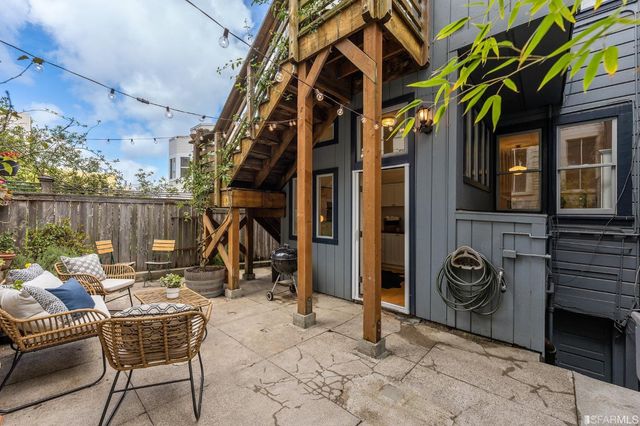 a view of roof deck with chair and tables