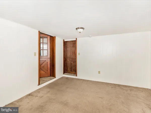 a view of a hallway with wooden floor and entryway