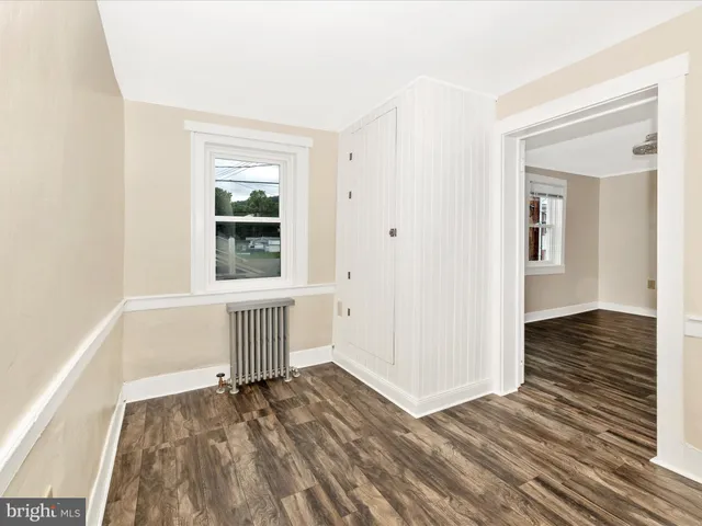 an empty room with windows and closet