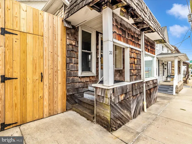 a view of a room with wooden floor and ceiling fan