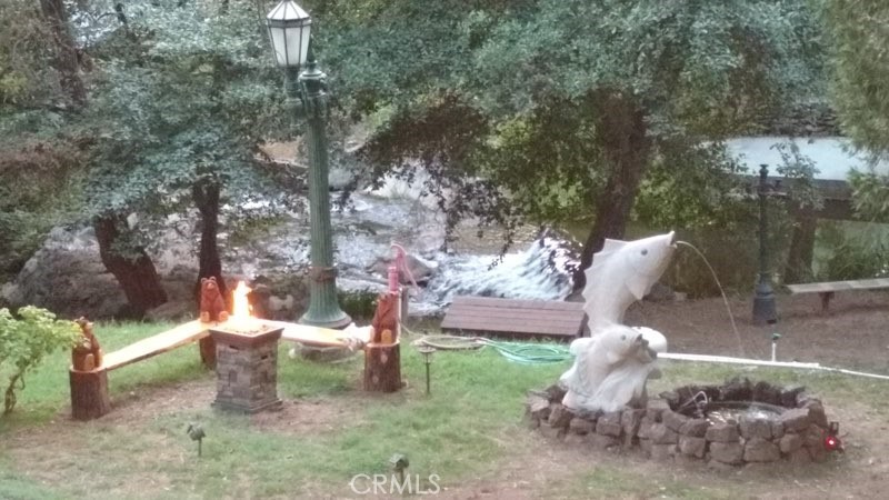 a view of a yard with a tree and a fire pit