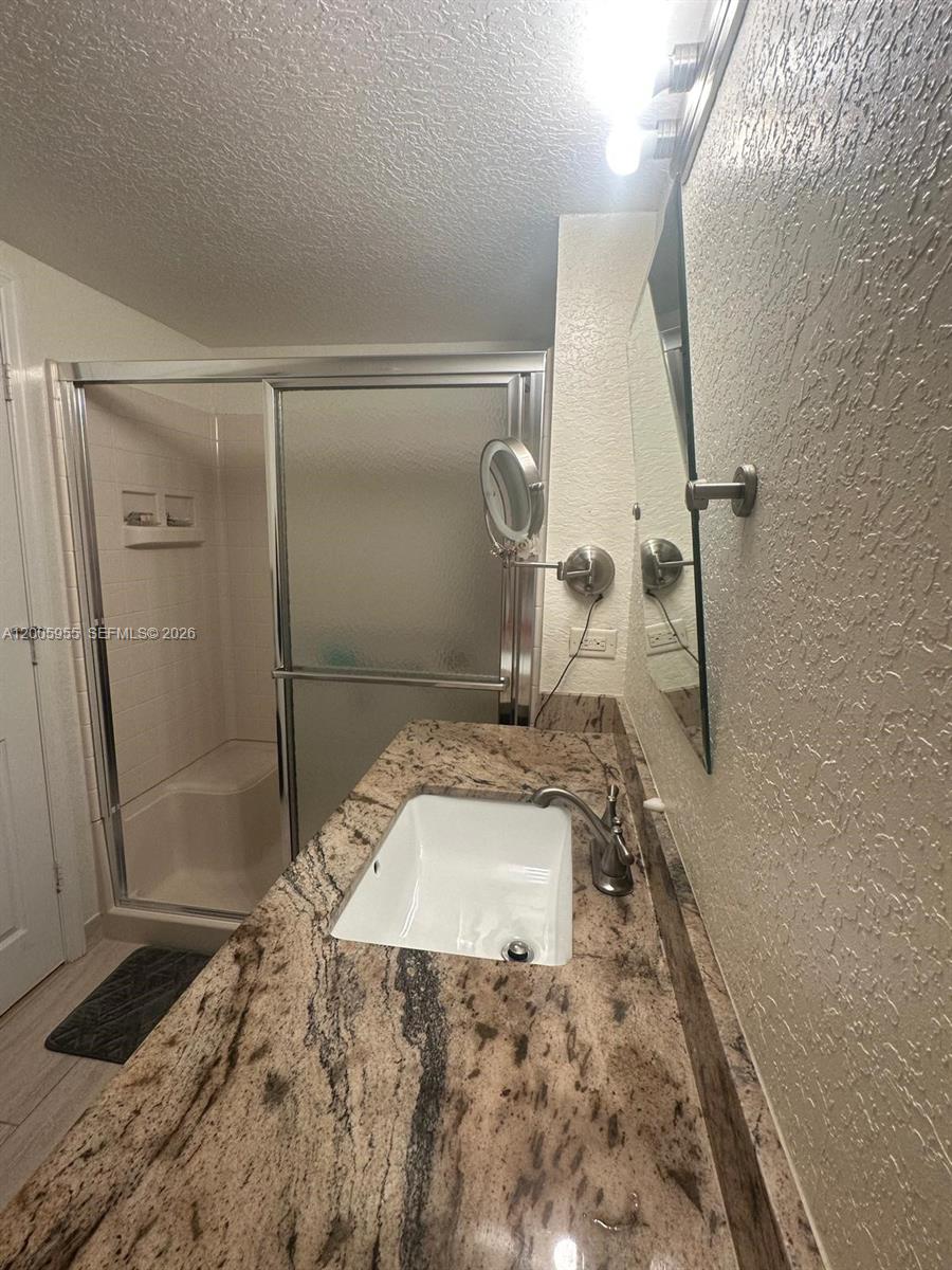 6920 West Sample Road, Unit 6920 Pompano Beach, FL 33063 - Photo 12 of 30 a bathroom with a sink and a mirror