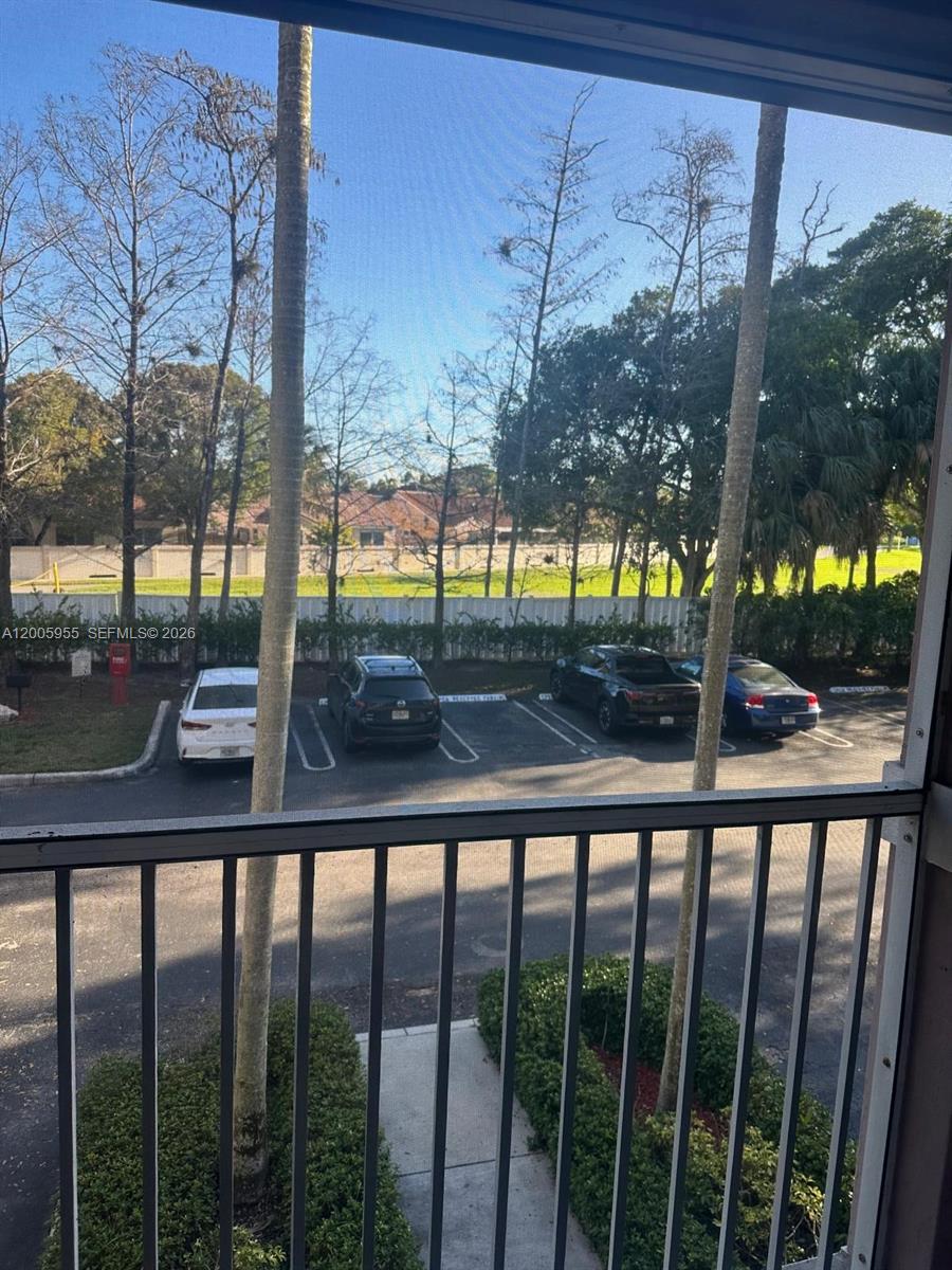 6920 West Sample Road, Unit 6920 Pompano Beach, FL 33063 - Photo 20 of 30 a view of trees from a balcony