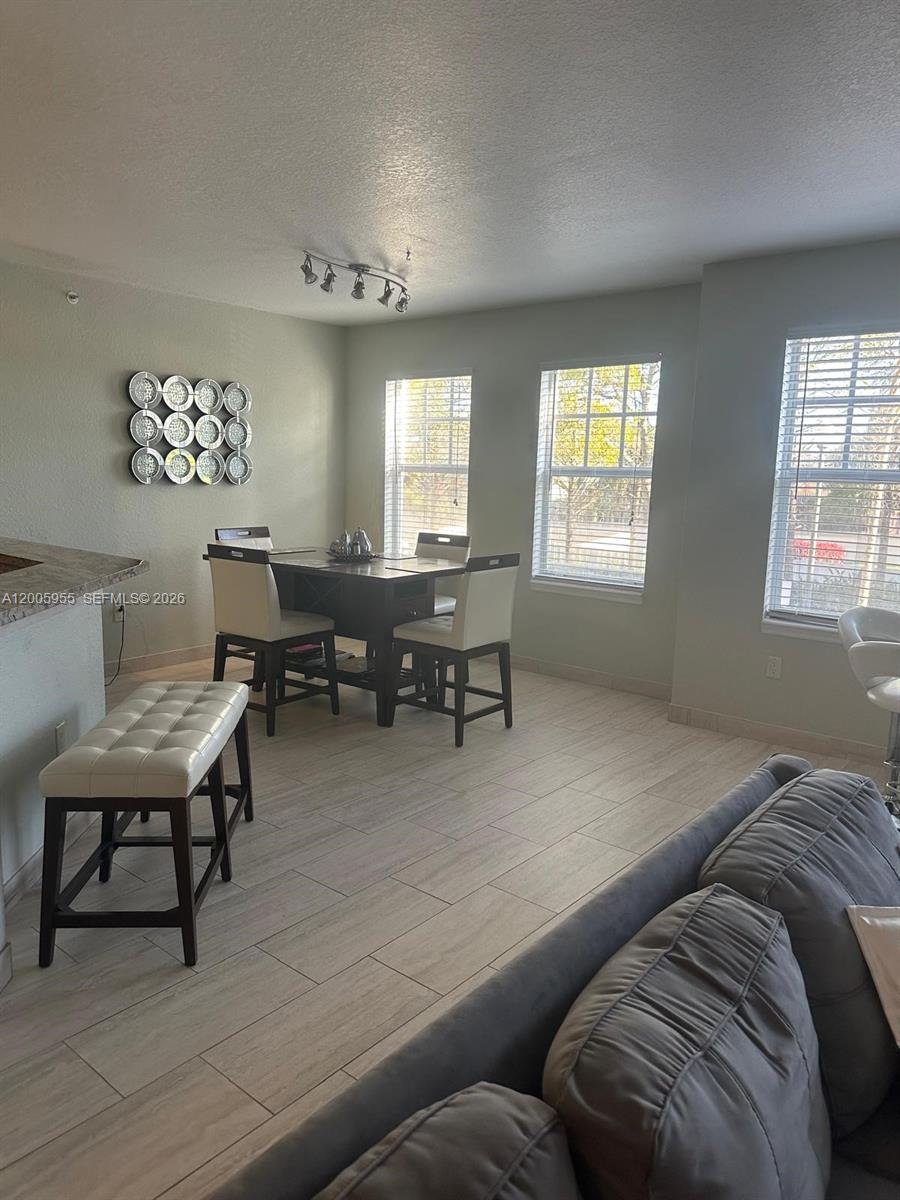 6920 West Sample Road, Unit 6920 Pompano Beach, FL 33063 - Photo 22 of 30 a living room with furniture and a large window