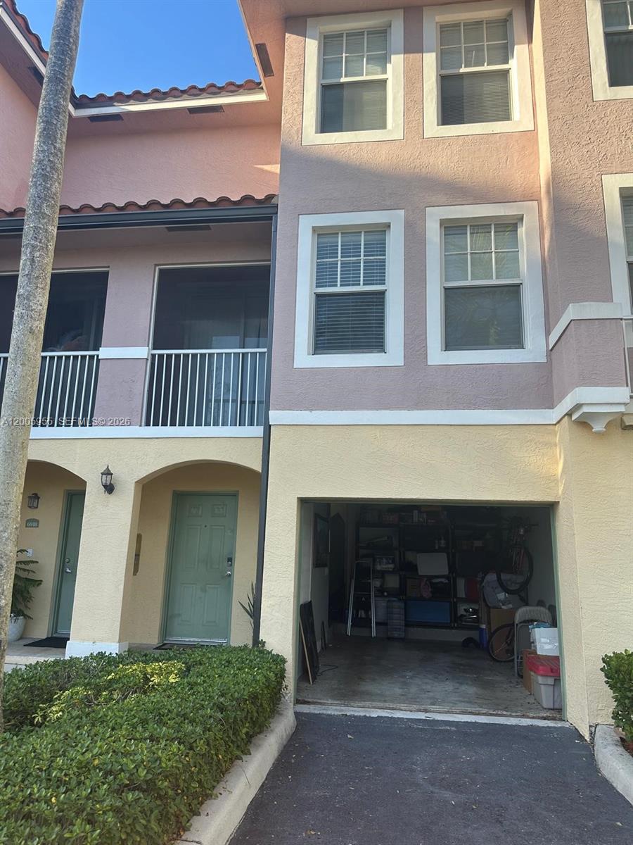 6920 West Sample Road, Unit 6920 Pompano Beach, FL 33063 - Photo 26 of 30 a view of a house with a barbeque and large window