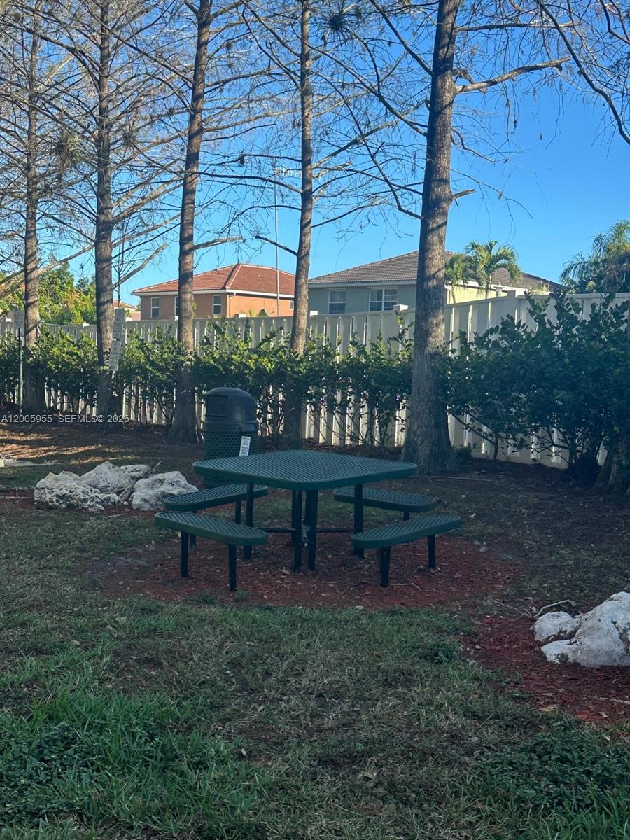6920 West Sample Road, Unit 6920 Pompano Beach, FL 33063 - Photo 29 of 30 a view of a bench in a yard