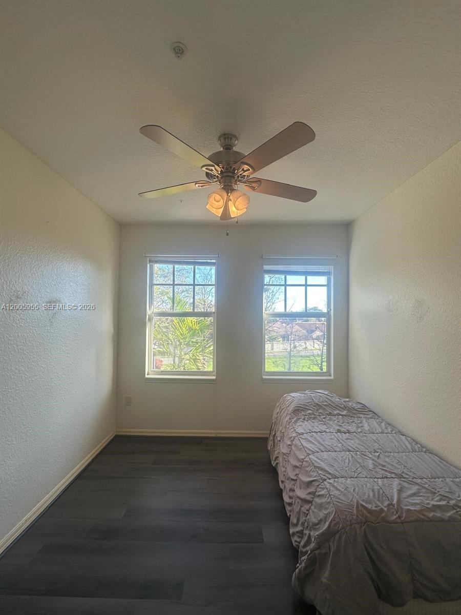 6920 West Sample Road, Unit 6920 Pompano Beach, FL 33063 - Photo 8 of 30 a bedroom with a bed and a window