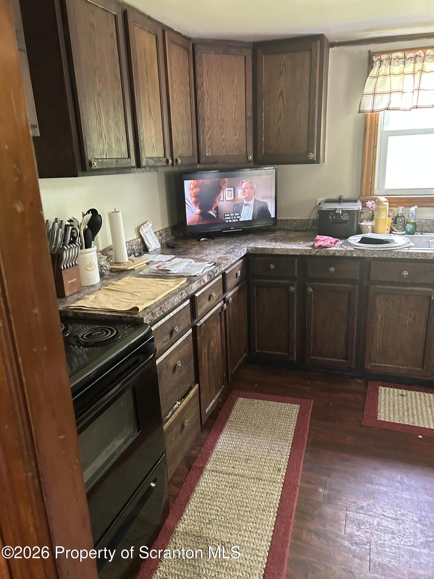 63 Shannon Street Simpson, PA 18407 - Photo 8 of 18 a kitchen with stainless steel appliances granite countertop a stove a sink and a microwave
