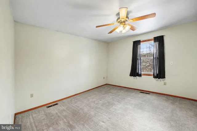 a view of a livingroom with wooden floor and stairs