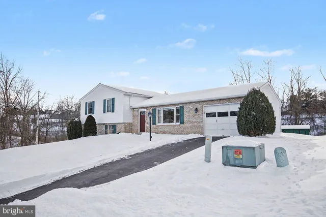 a view of a white house with a yard