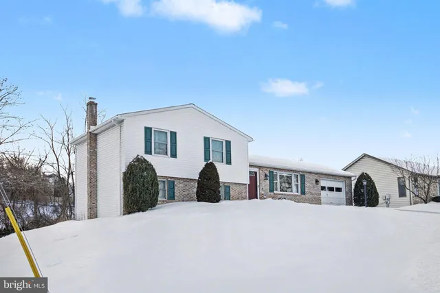 a view of a house with a snow in the yard