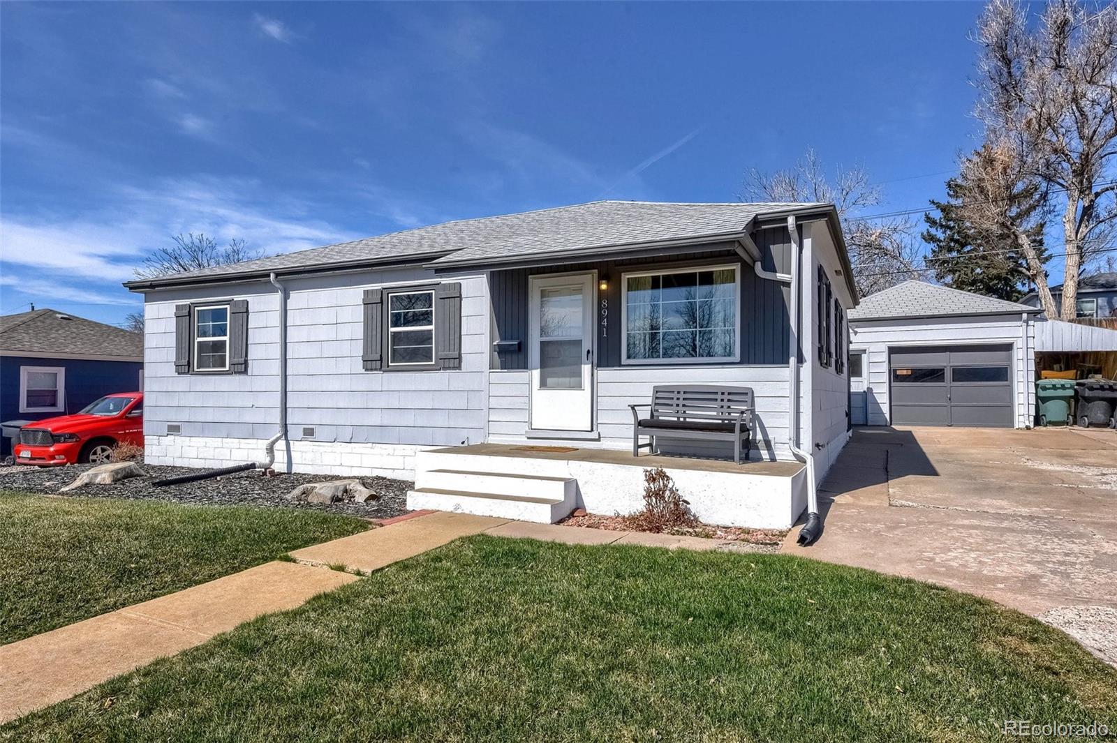 a view of a house with backyard and sitting area