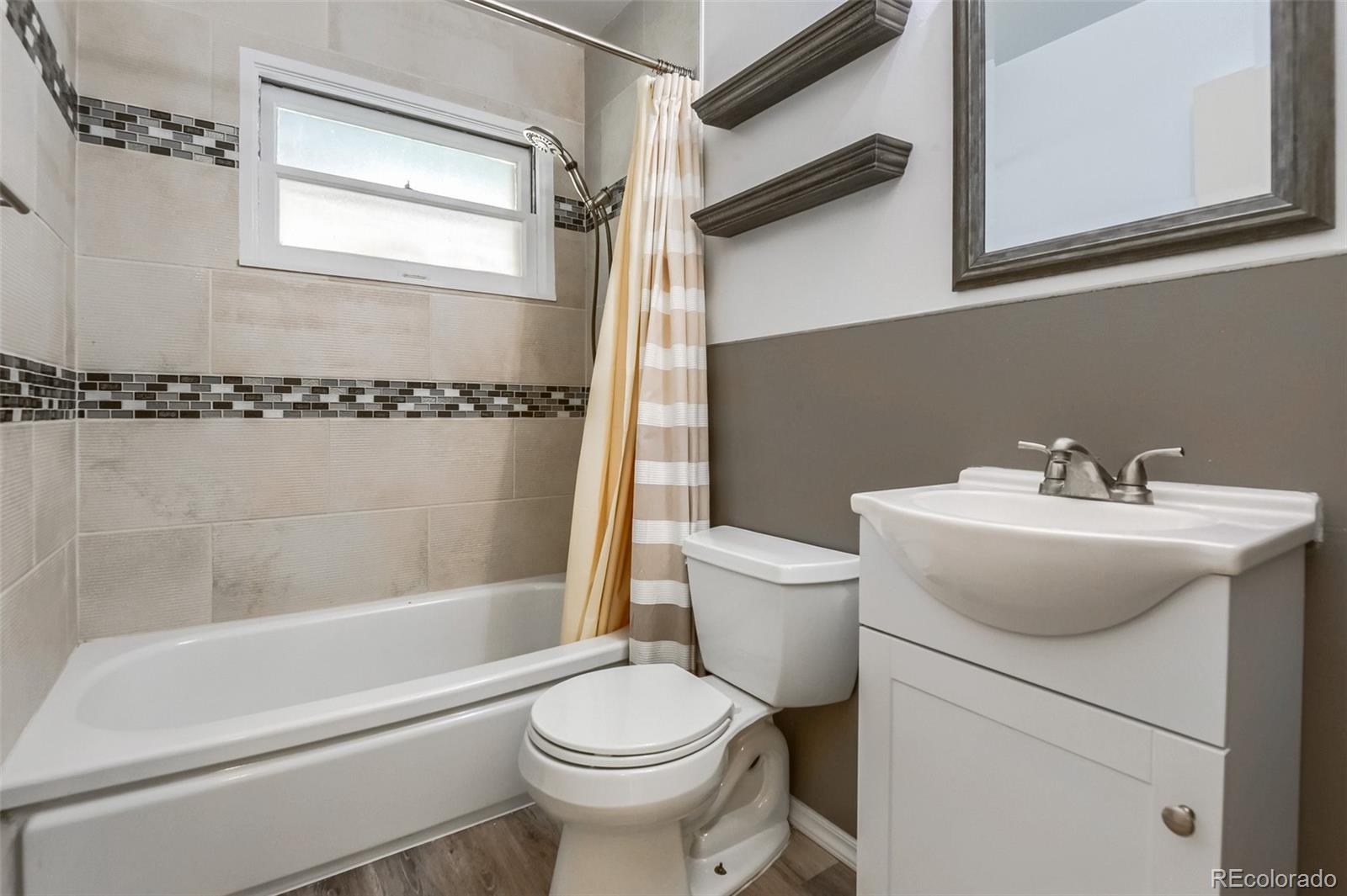 8941 Lilly Drive Thornton, CO 80229 - Photo 15 of 27 a bathroom with a sink toilet and shower