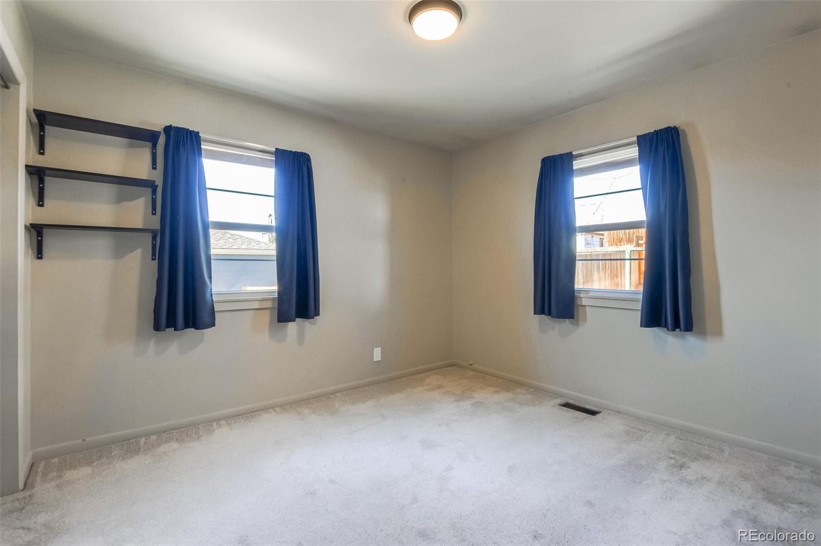 8941 Lilly Drive Thornton, CO 80229 - Photo 20 of 27 an empty room with windows and closet