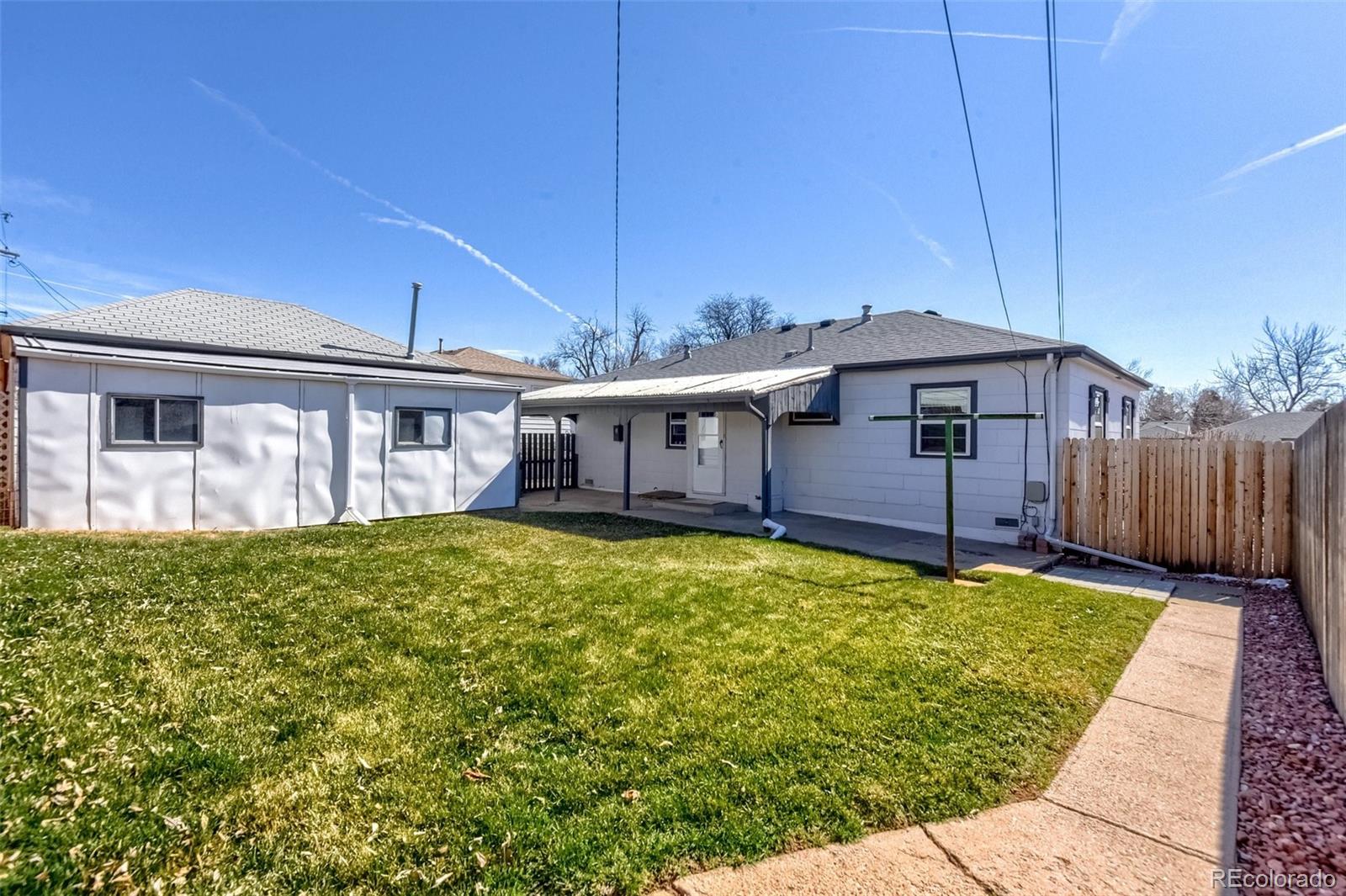 8941 Lilly Drive Thornton, CO 80229 - Photo 25 of 27 a view of a house with wooden floor and a yard