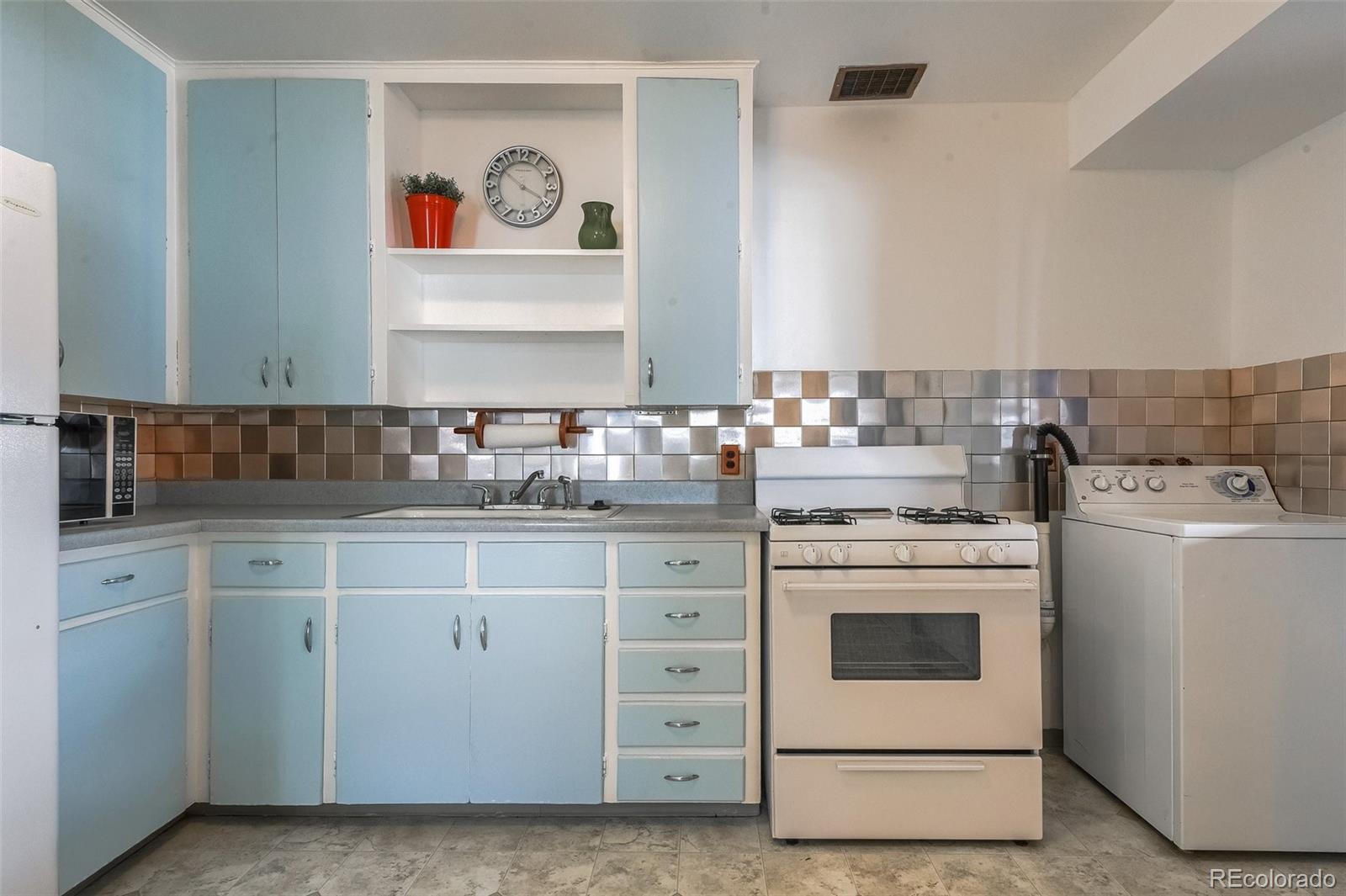 8941 Lilly Drive Thornton, CO 80229 - Photo 10 of 27 a kitchen with cabinets appliances and a sink