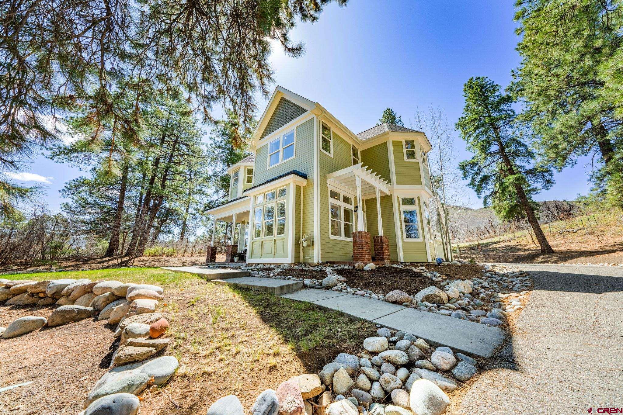 823 The Eagle Pass Durango, CO 81301 - Photo 1 of 42 a front view of a house with a yard