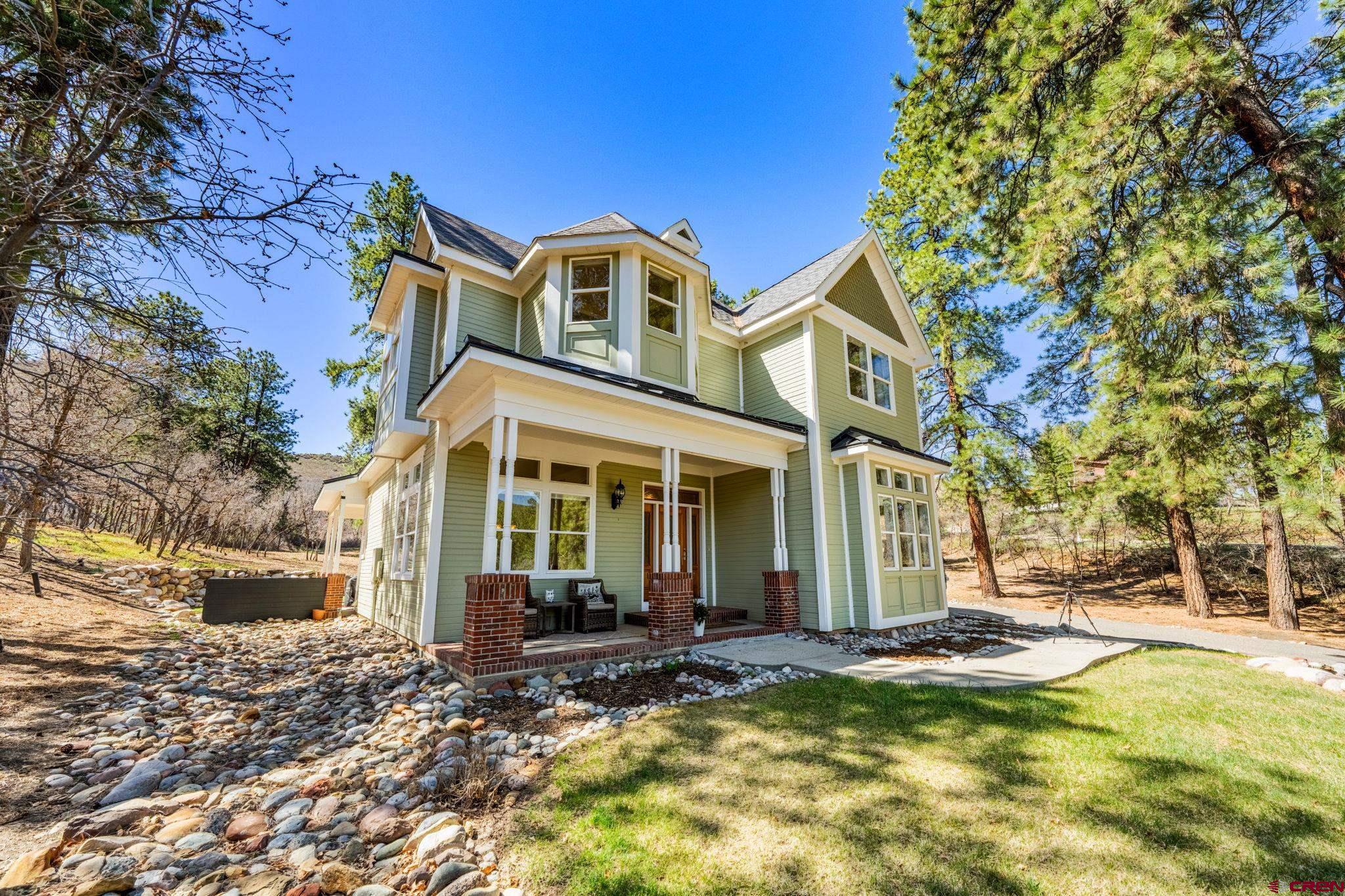 823 The Eagle Pass Durango, CO 81301 - Photo 2 of 42 a front view of a house with a yard table and chairs