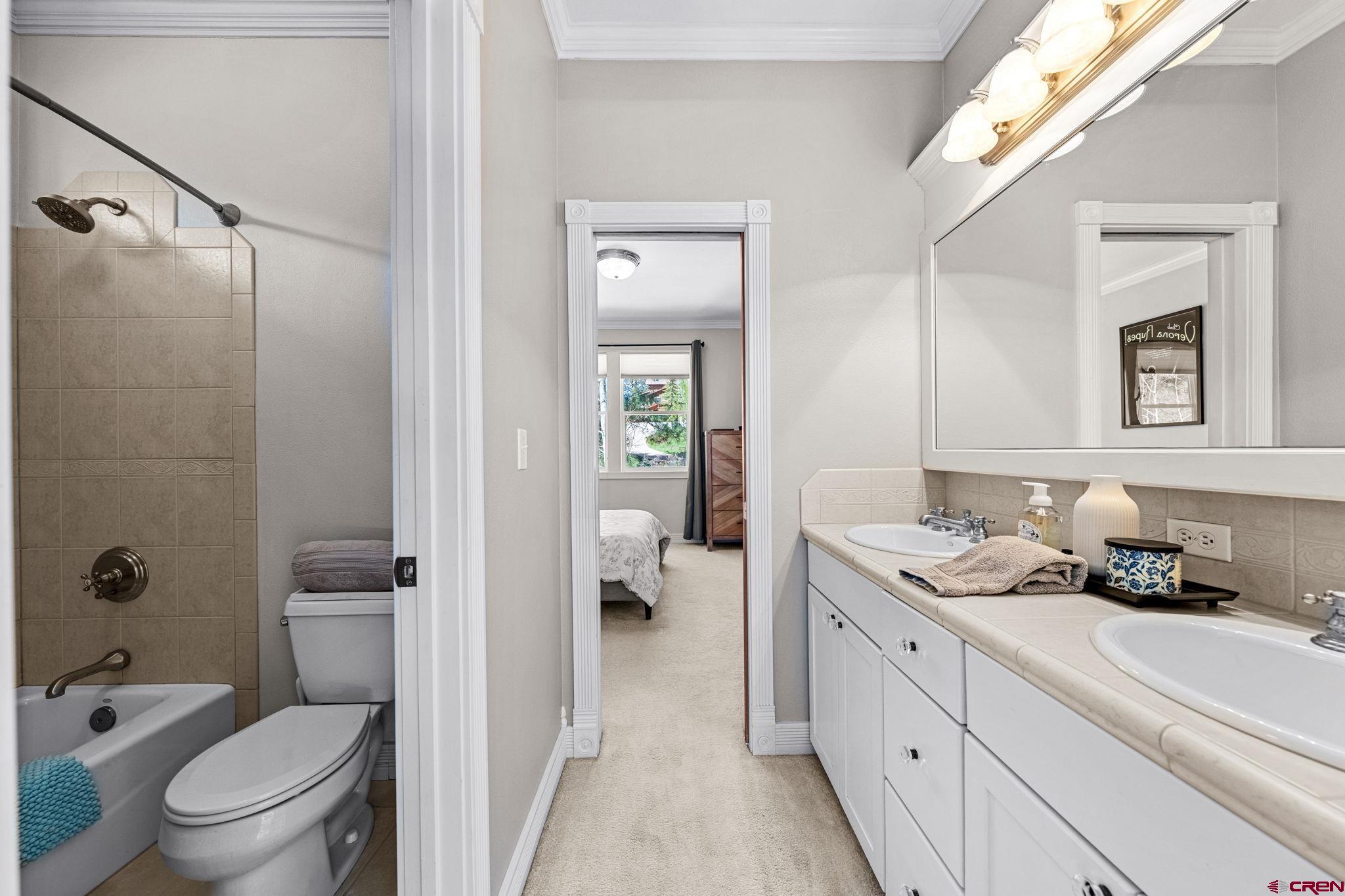 823 The Eagle Pass Durango, CO 81301 - Photo 36 of 42 a bathroom with a granite countertop sink a toilet and shower
