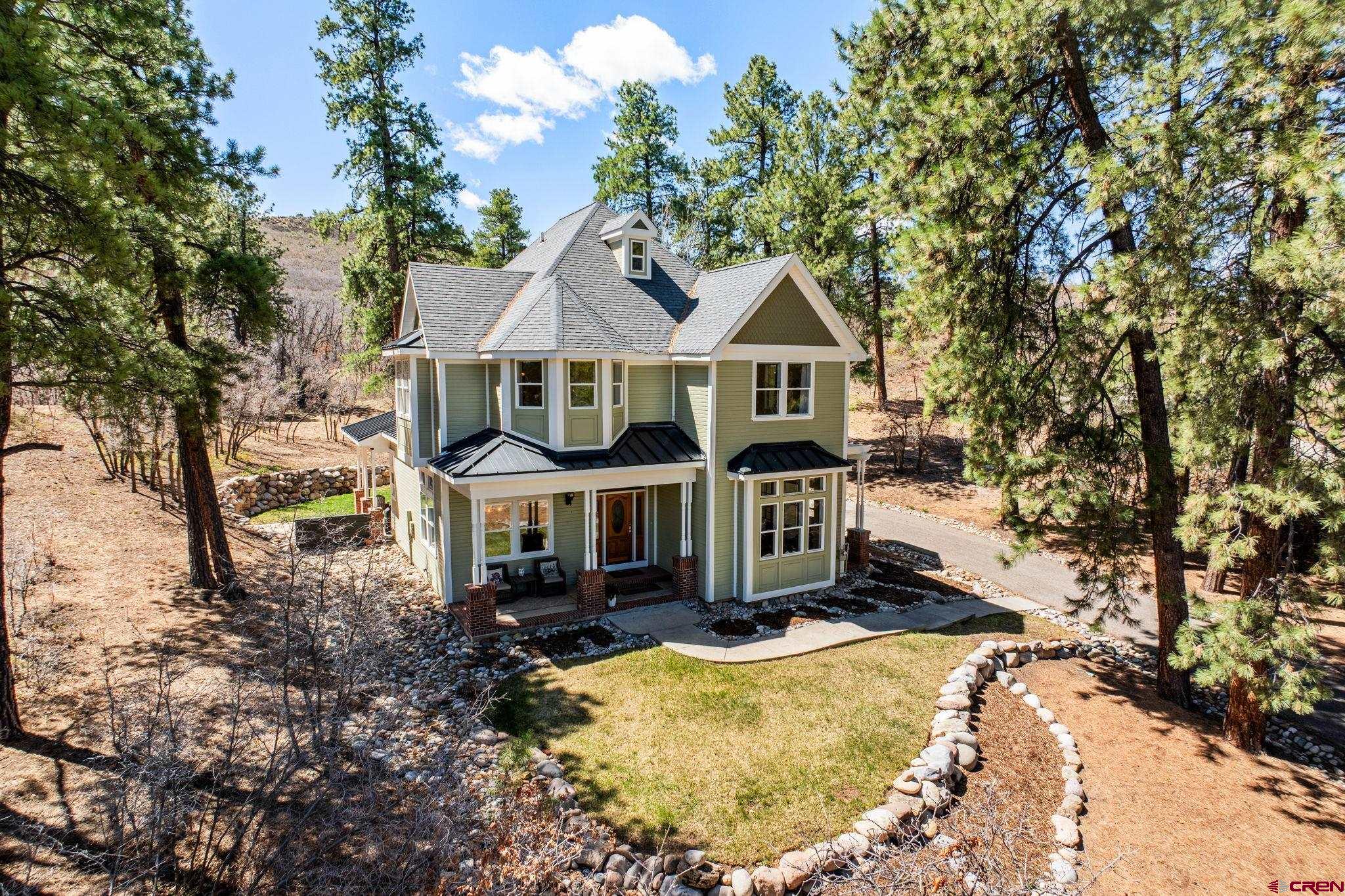 823 The Eagle Pass Durango, CO 81301 - Photo 4 of 42 front view of a house with a yard