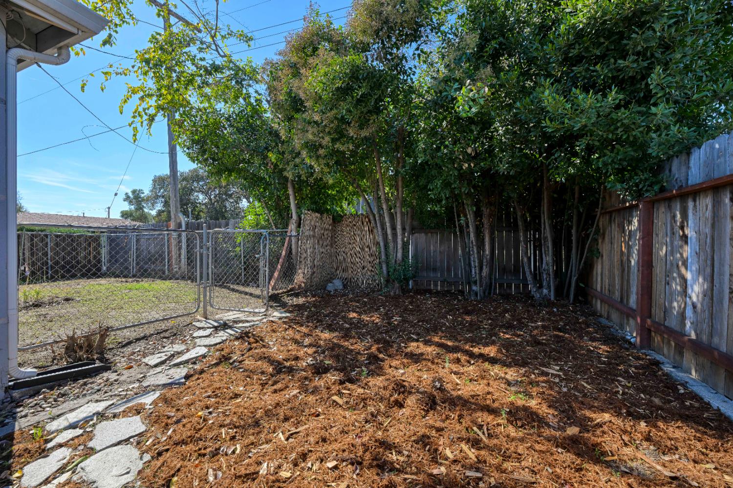 325 Archway Avenue Rio Linda, CA 95673 - Photo 26 of 29 a view of a backyard with wooden fence and a large tree