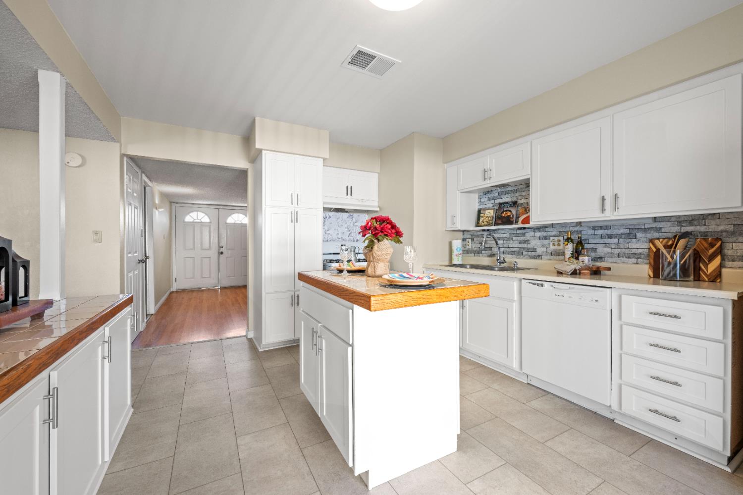 325 Archway Avenue Rio Linda, CA 95673 - Photo 9 of 29 a kitchen with granite countertop a sink stove refrigerator and white cabinets