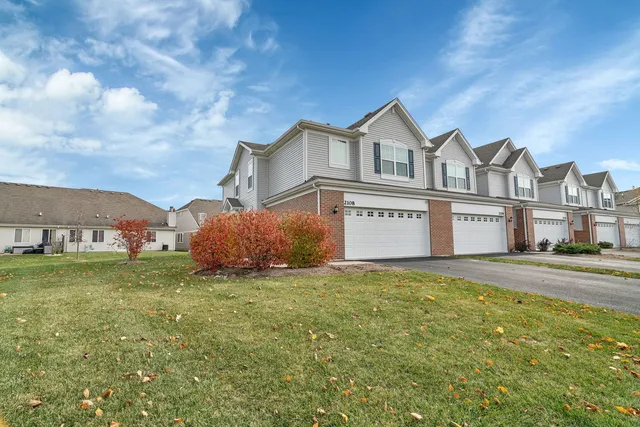 a view of a house with a yard and garage