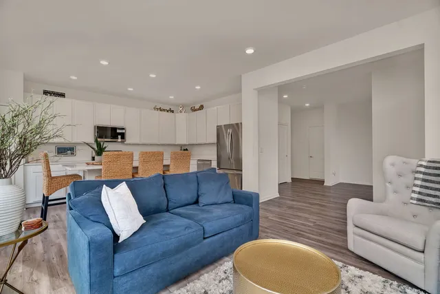a living room with furniture and kitchen view