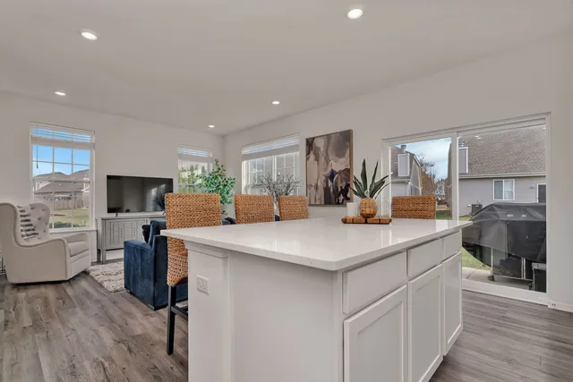 a kitchen with kitchen island a sink appliances and cabinets