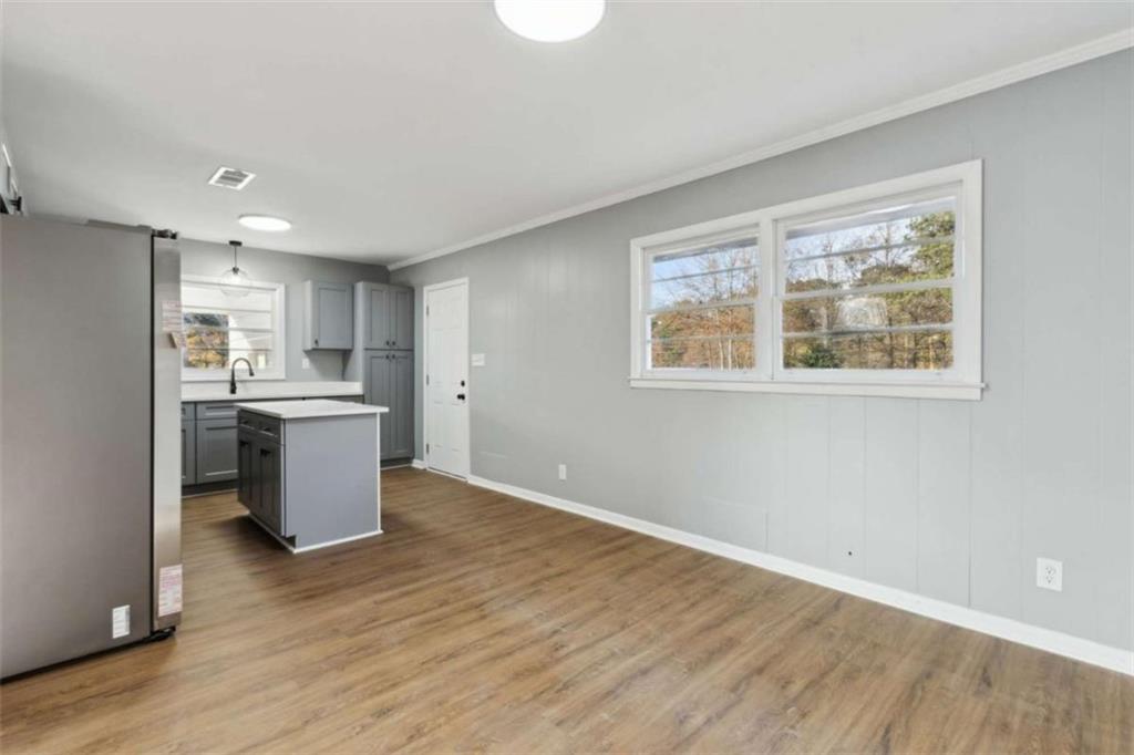 269 Elks Street Winder, GA 30680 - Photo 12 of 42 a kitchen with a wooden floor and a window