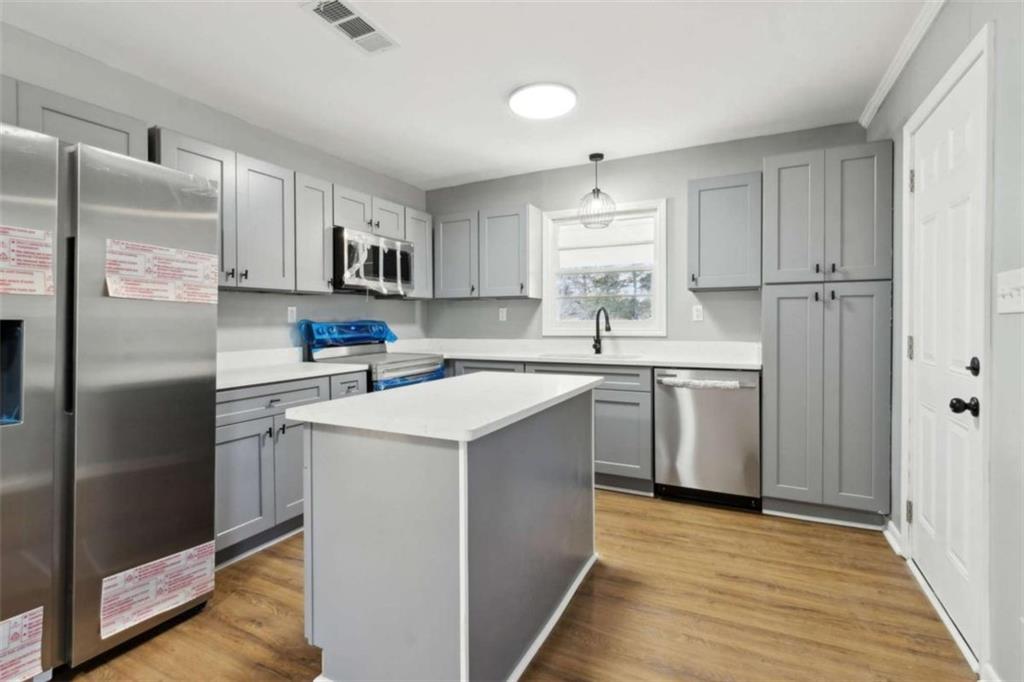 269 Elks Street Winder, GA 30680 - Photo 15 of 42 a kitchen with a sink a refrigerator a counter top space and cabinets