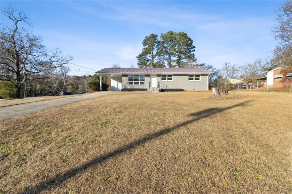 269 Elks Street Winder, GA 30680 - Photo 2 of 42 a front view of a house with a yard and garage