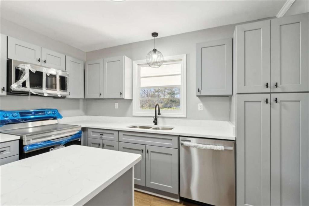 269 Elks Street Winder, GA 30680 - Photo 23 of 42 a kitchen with stainless steel appliances a sink a stove a refrigerator and cabinets
