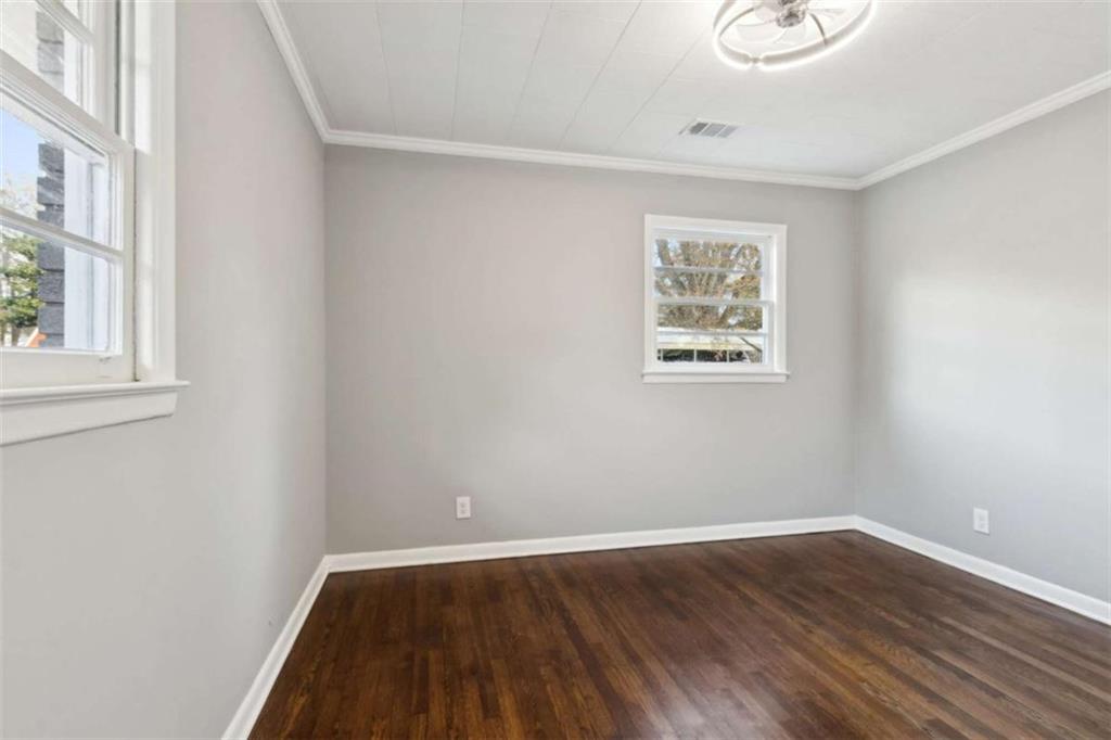 269 Elks Street Winder, GA 30680 - Photo 27 of 42 a view of an empty room with wooden floor and a window