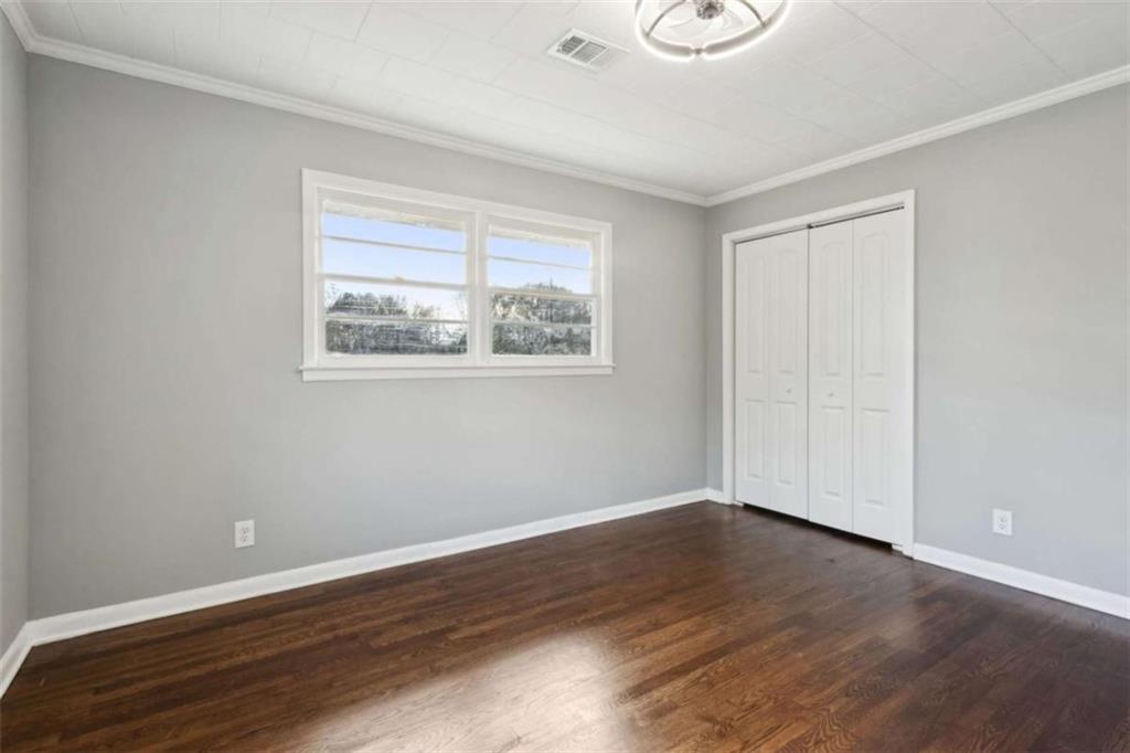 269 Elks Street Winder, GA 30680 - Photo 30 of 42 a view of an empty room with wooden floor and a window