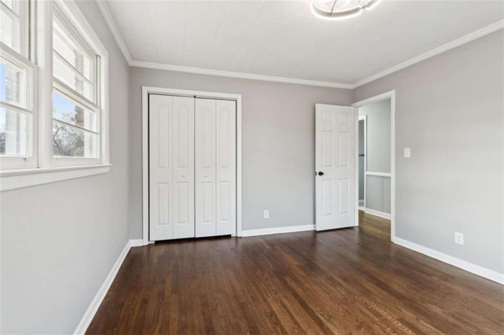 269 Elks Street Winder, GA 30680 - Photo 31 of 42 an empty room with wooden floor and windows