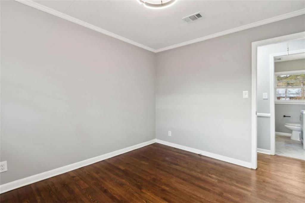 269 Elks Street Winder, GA 30680 - Photo 38 of 42 a view of an empty room with wooden floor and a window