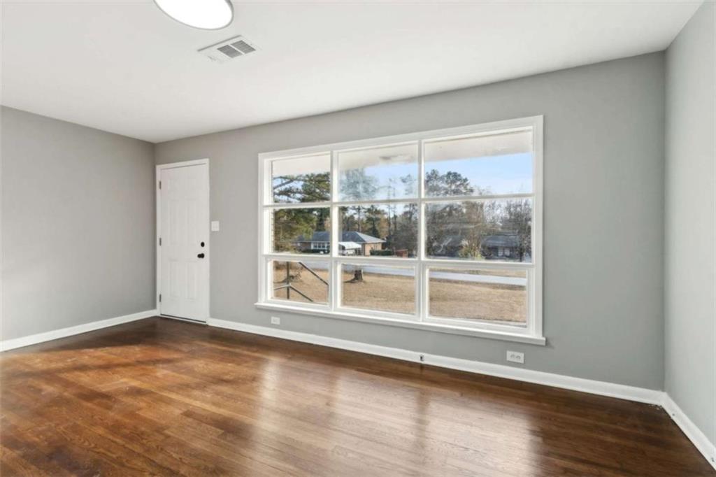 269 Elks Street Winder, GA 30680 - Photo 8 of 42 a view of an empty room with wooden floor and a window