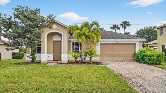 a front view of a house with a garden and yard