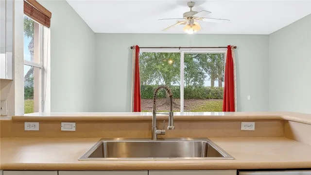 a view of a kitchen with a sink and a window