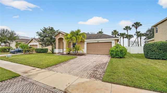 a front view of house with yard and green space