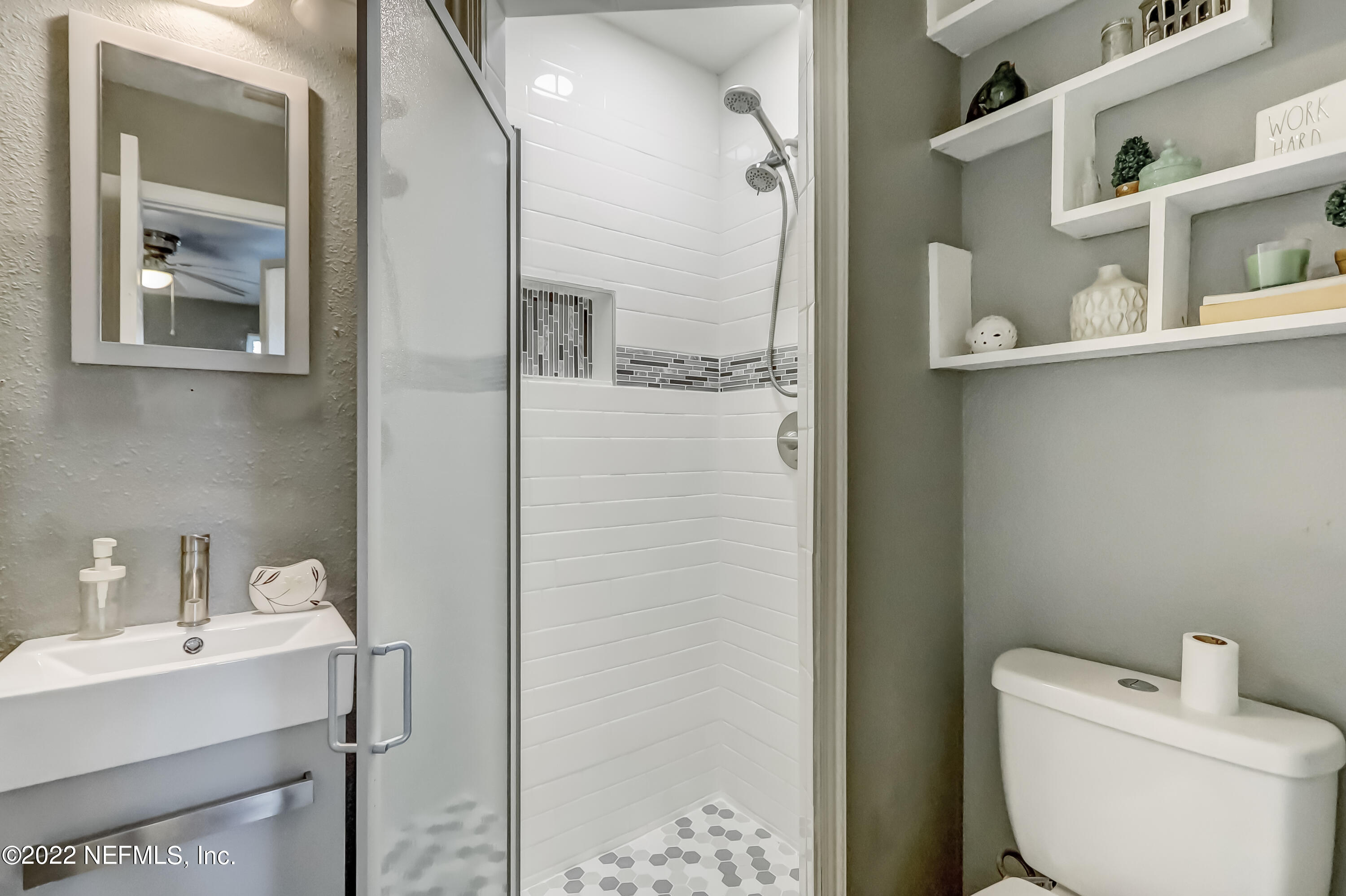 4816 Andromeda Road Jacksonville, FL 32210 - Photo 14 of 26 a bathroom with a toilet sink and shower