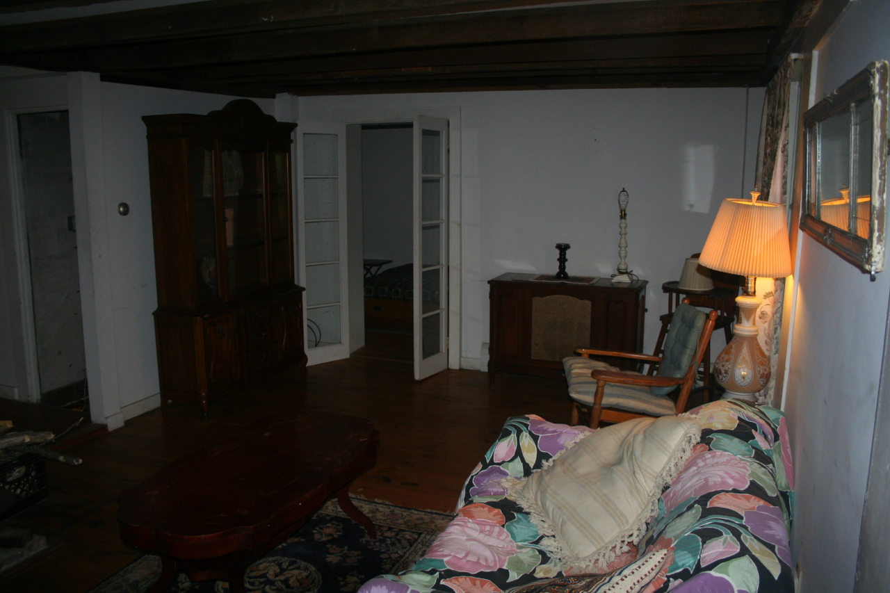 147 Sandisfield Road Sandisfield, MA 01255 - Photo 16 of 26 a living room with furniture and a lamp on table