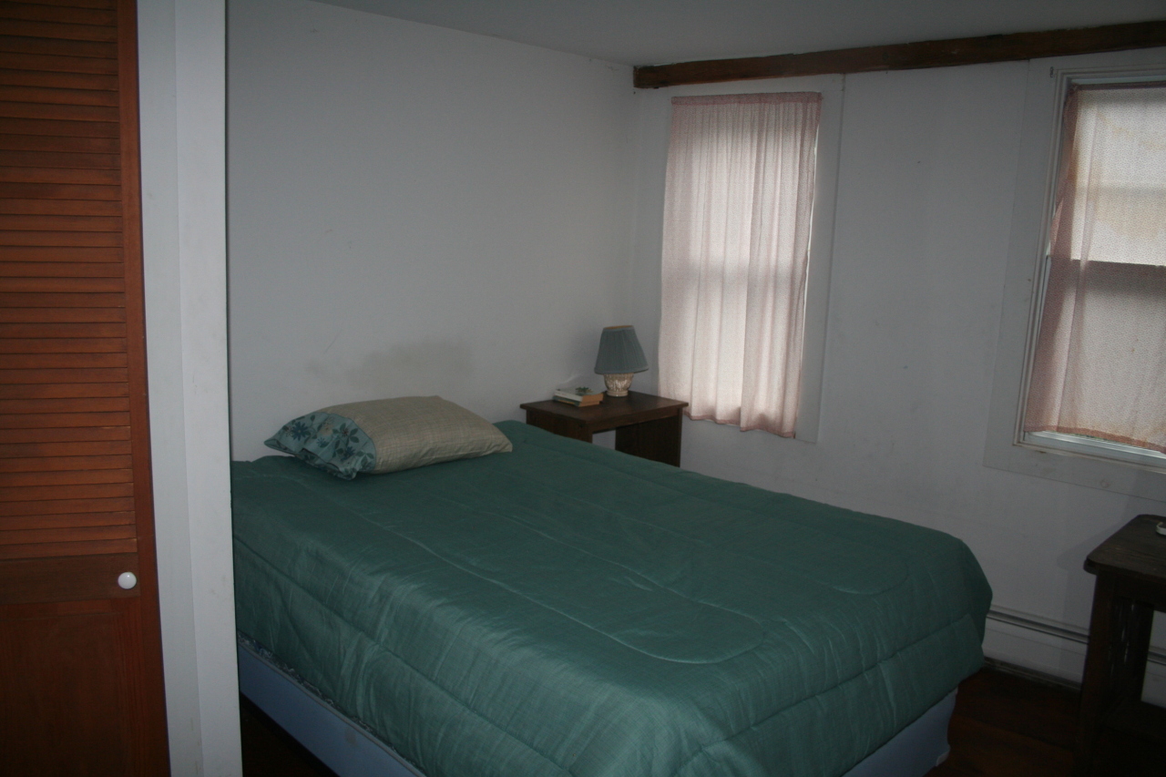 147 Sandisfield Road Sandisfield, MA 01255 - Photo 20 of 26 a bedroom with a bed and a window