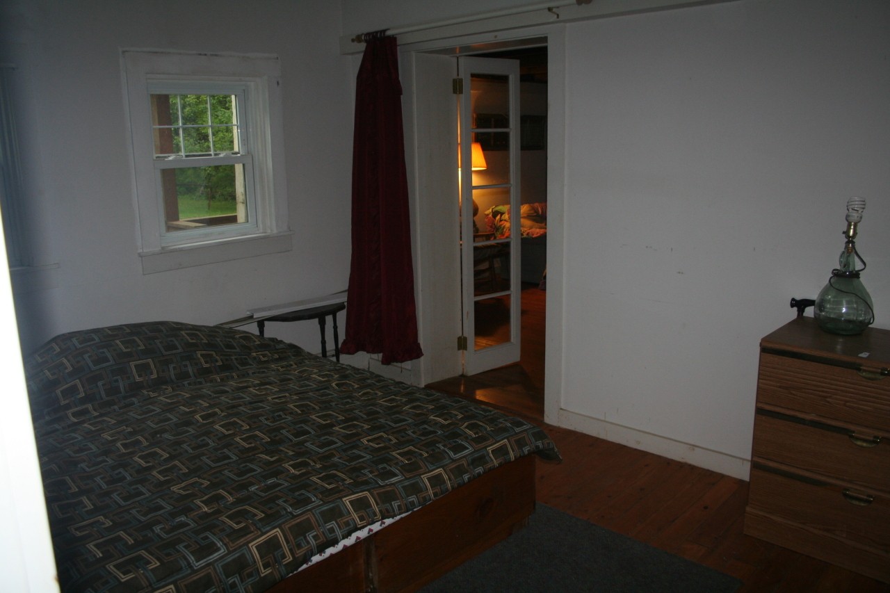 147 Sandisfield Road Sandisfield, MA 01255 - Photo 24 of 26 a bed sitting in a bedroom next to a window