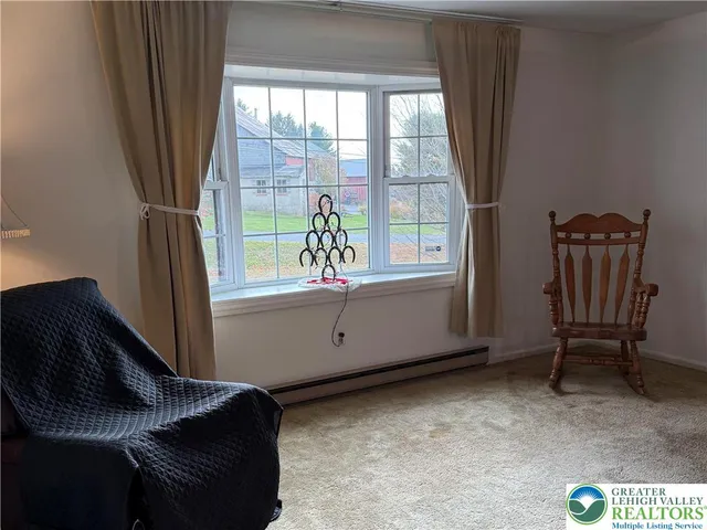 a kitchen with stainless steel appliances a sink a stove a refrigerator cabinets and a window