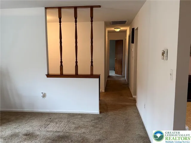 a kitchen with a sink window and cabinets