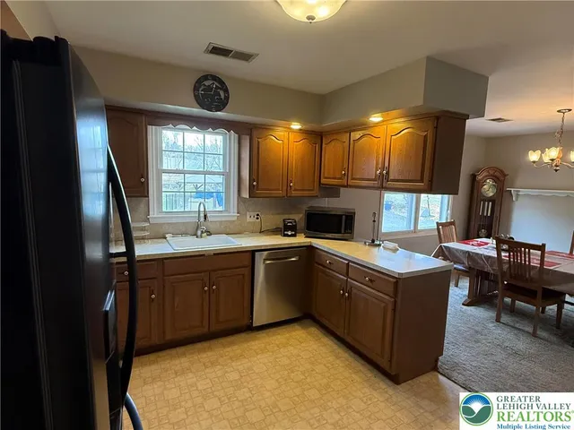 a living room with furniture a fireplace and a floor to ceiling window