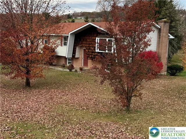 a view of a wooden house with a yard